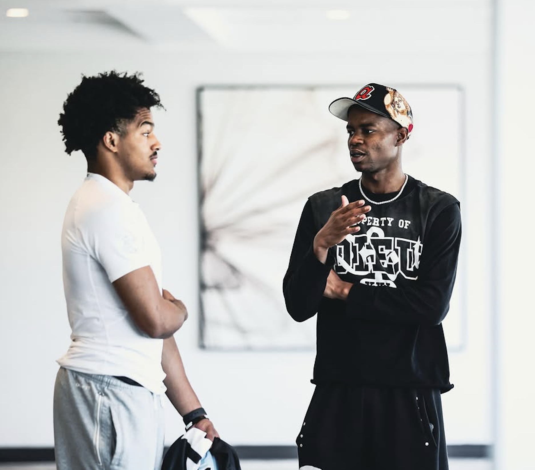 Coinlete partner talking with an athlete inside a training facility