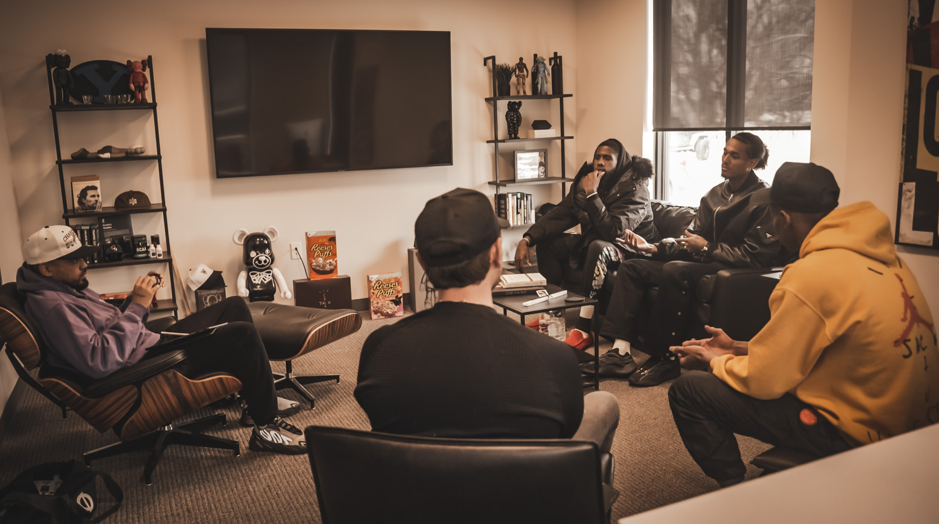 Athletes and operators in a working strategy session at the Coinlete office